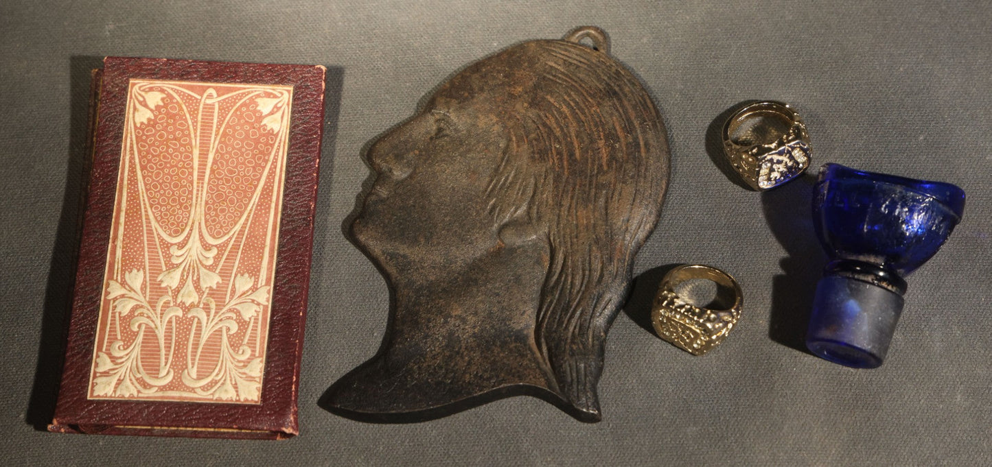 Grouping of Five Vintage and Antique Smalls including Cast Metal Washington Profile Plaque, Art Nouveau Miniature Needle Book, Wyeth Eye Wash Cobalt Blue Glass Stopper, and Two Ornate Costume Rings