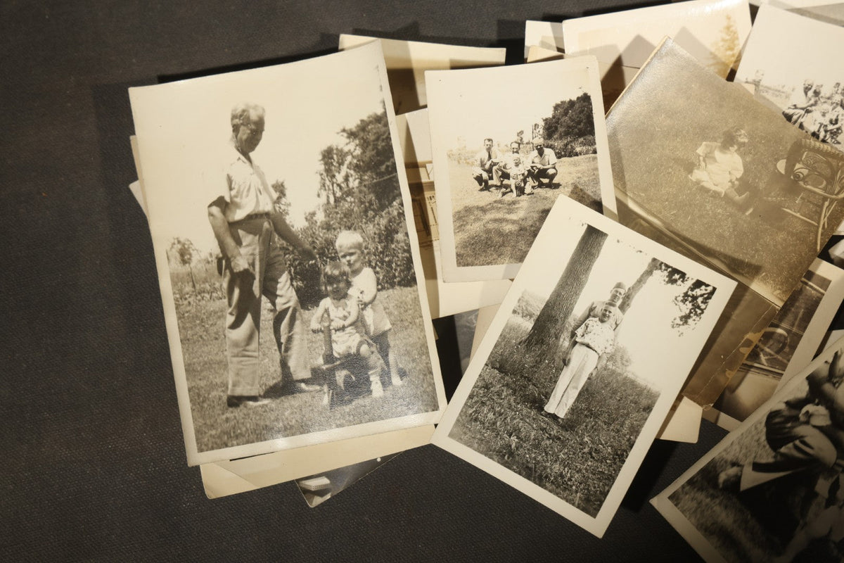 Grouping of 25+ Antique and Vintage Snapshot Photographs including Christmas Tree Portraits, Children with Dogs, Residential Architecture, and Family Scenes