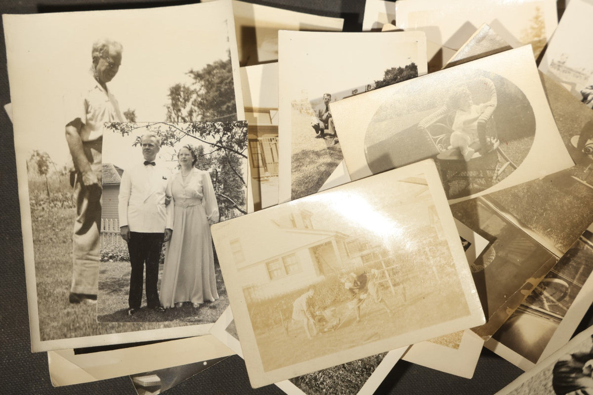 Grouping of 25+ Antique and Vintage Snapshot Photographs including Christmas Tree Portraits, Children with Dogs, Residential Architecture, and Family Scenes