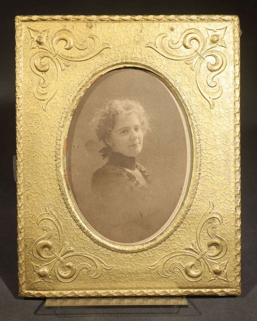 Pair of Antique Photographs including Woman in Gold-Painted Embossed Frame with Oval Window and Board-Mounted Portrait of a Young Girl with Decorative Border