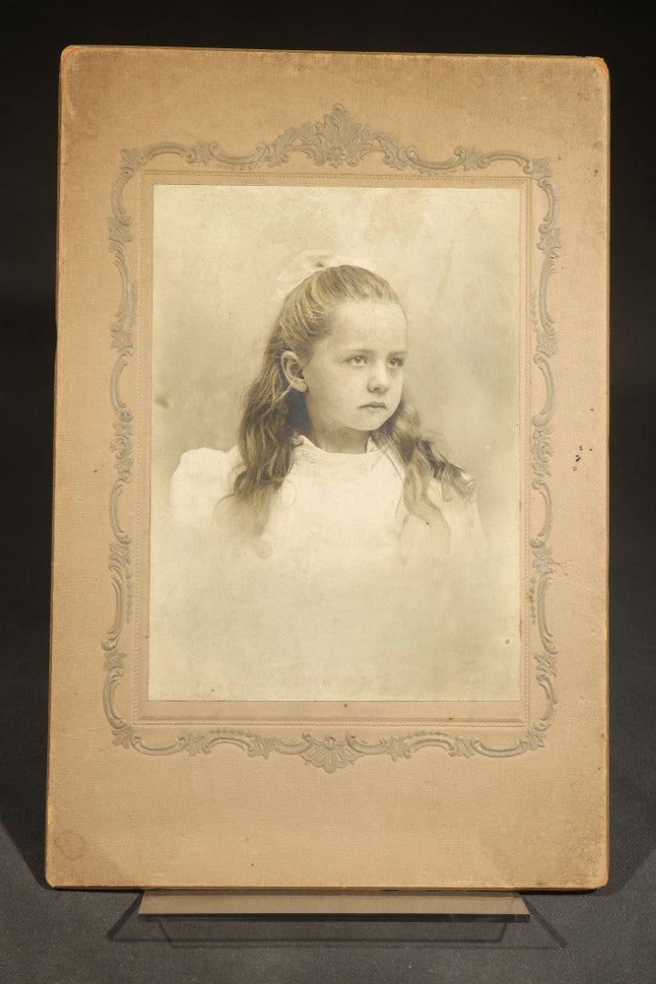 Pair of Antique Photographs including Woman in Gold-Painted Embossed Frame with Oval Window and Board-Mounted Portrait of a Young Girl with Decorative Border