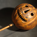 Lot 001 - Antique Pressed Tin Halloween Jack-O-Lantern Pumpkin Parade Lantern on Bamboo Stick with Interior Candle Cup, Attributed to Toledo Metal Sign Company, Toledo, Ohio, Circa 1905-1910, 6-1/2" W