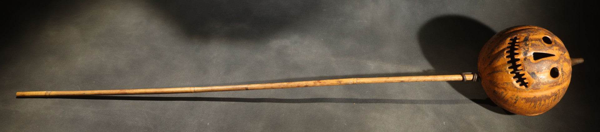 Antique Pressed Tin Halloween Jack-O-Lantern Pumpkin Parade Lantern on Bamboo Stick with Interior Candle Cup, Attributed to Toledo Metal Sign Company, Toledo, Ohio, Circa 1905-1910