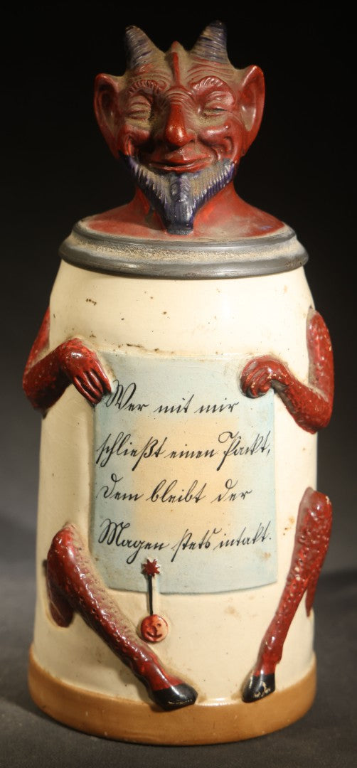 Antique German Figural Devil Beer Stein with Pewter Rimmed Lid, "Wer mit mir schließt einen Pakt, dem bleibt der Magen stets intakt" ("Whoever Makes a Pact with Me, Their Stomach Will Always Remain Intact"), Mold 1565