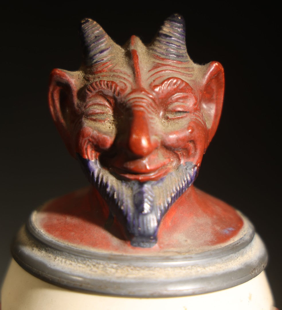 Antique German Figural Devil Beer Stein with Pewter Rimmed Lid, "Wer mit mir schließt einen Pakt, dem bleibt der Magen stets intakt" ("Whoever Makes a Pact with Me, Their Stomach Will Always Remain Intact"), Mold 1565