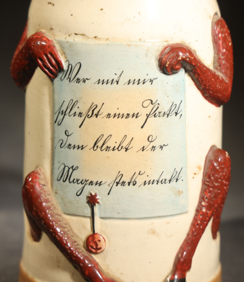 Antique German Figural Devil Beer Stein with Pewter Rimmed Lid, "Wer mit mir schließt einen Pakt, dem bleibt der Magen stets intakt" ("Whoever Makes a Pact with Me, Their Stomach Will Always Remain Intact"), Mold 1565