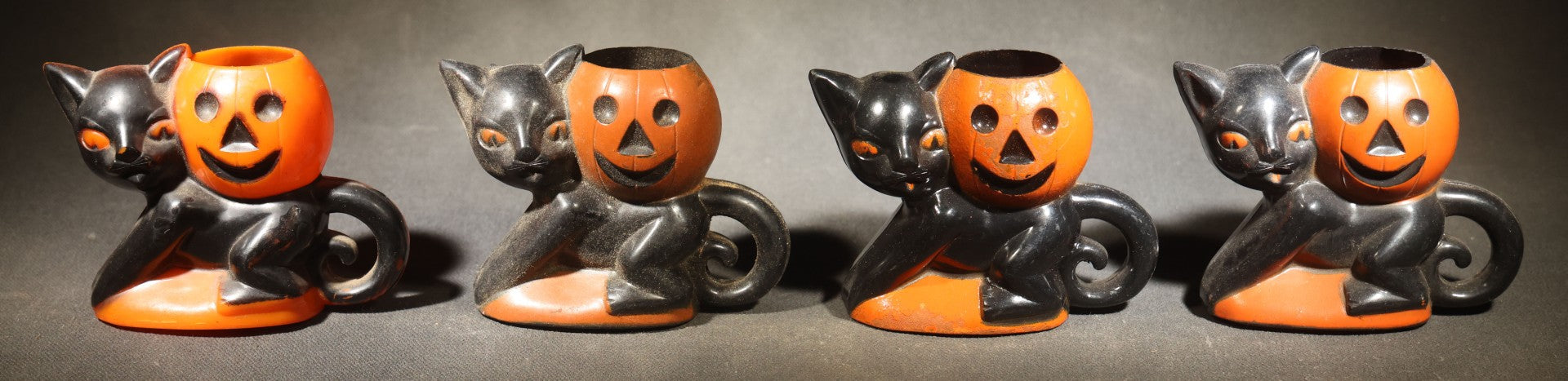 Grouping of Four Vintage Plastic Halloween Cat Holding Jack-O-Lantern Candy Containers, Circa 1950s, Manufactured by Rosbro Plastics, Pawtucket, Rhode Island