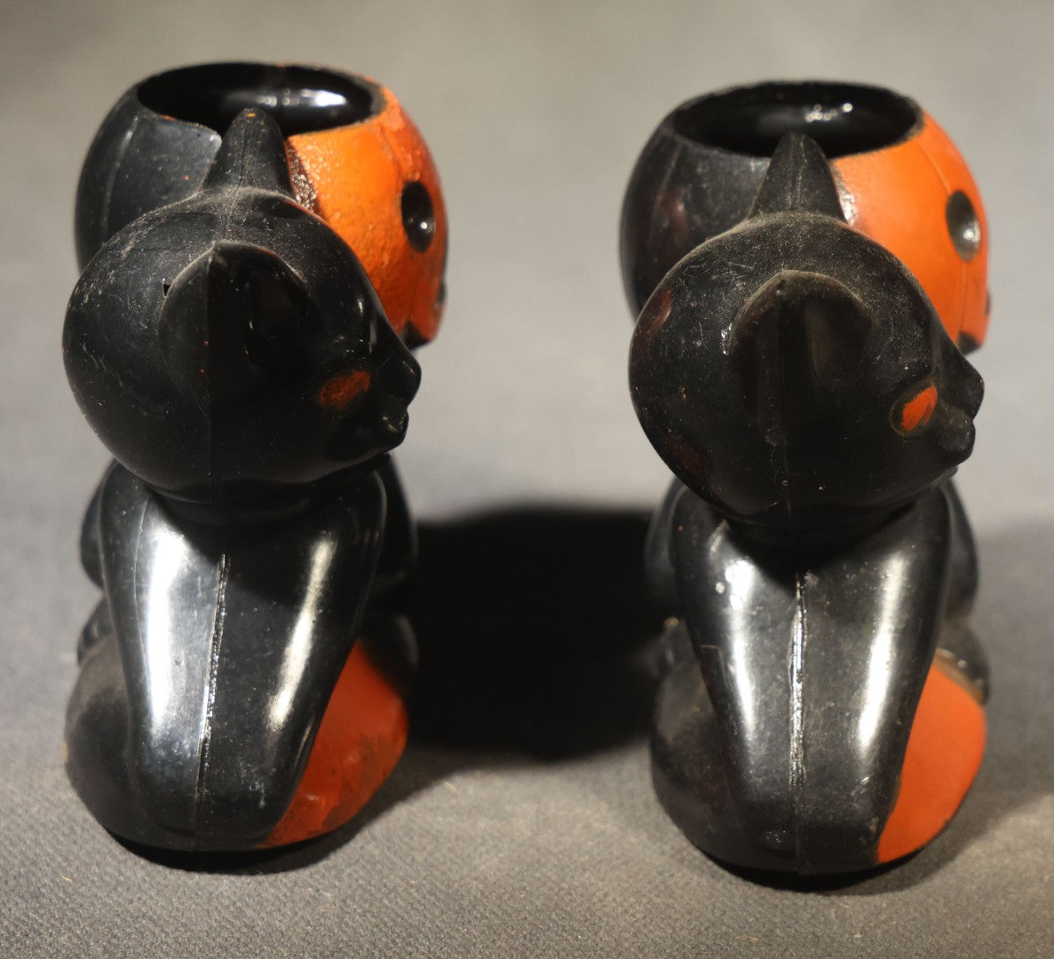 Grouping of Four Vintage Plastic Halloween Cat Holding Jack-O-Lantern Candy Containers, Circa 1950s, Manufactured by Rosbro Plastics, Pawtucket, Rhode Island
