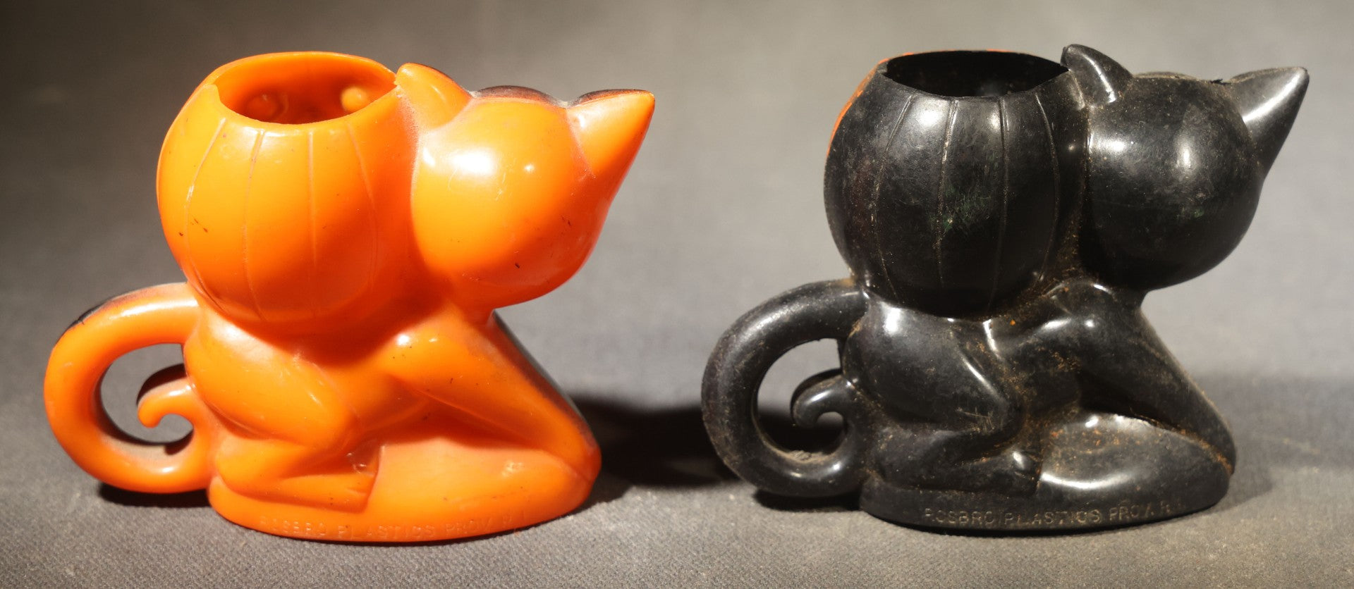 Grouping of Four Vintage Plastic Halloween Cat Holding Jack-O-Lantern Candy Containers, Circa 1950s, Manufactured by Rosbro Plastics, Pawtucket, Rhode Island