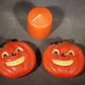 Lot 064 - Grouping of Three Modern Halloween Candles Including Two Grinning Jack-O-Lantern Pumpkin Figural Candles and One Orange Votive Candle