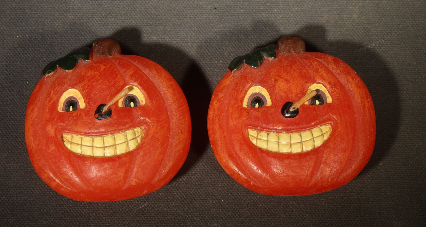 Grouping of Three Modern Halloween Candles including Two Grinning Jack-O-Lantern Pumpkin Figural Candles and One Orange Votive Candle