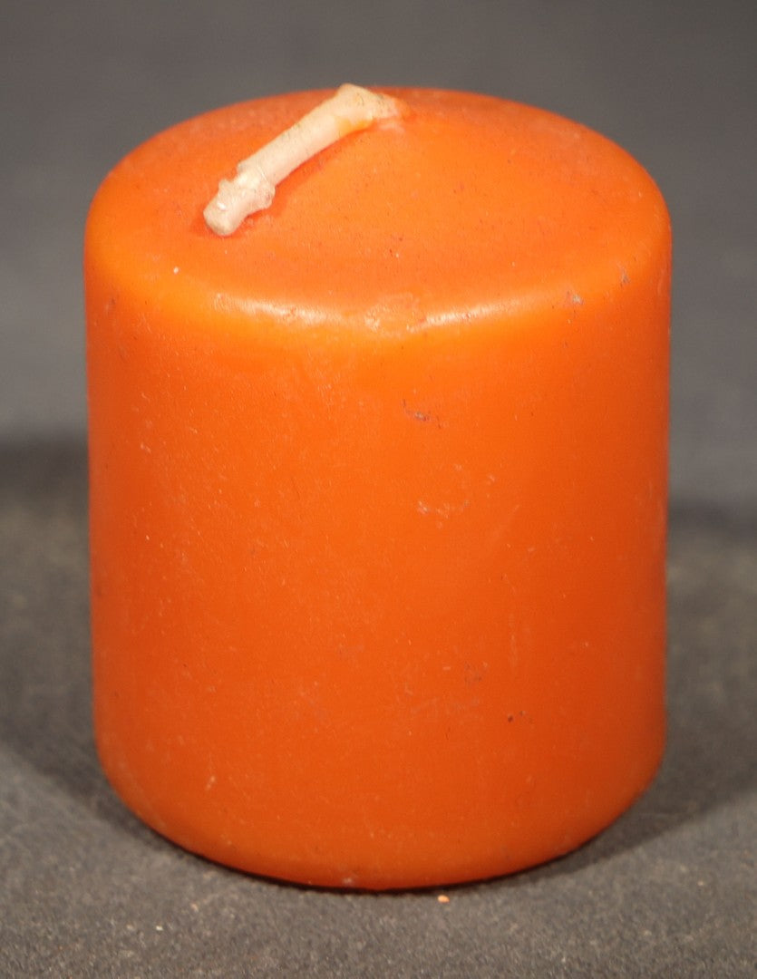Grouping of Three Modern Halloween Candles including Two Grinning Jack-O-Lantern Pumpkin Figural Candles and One Orange Votive Candle