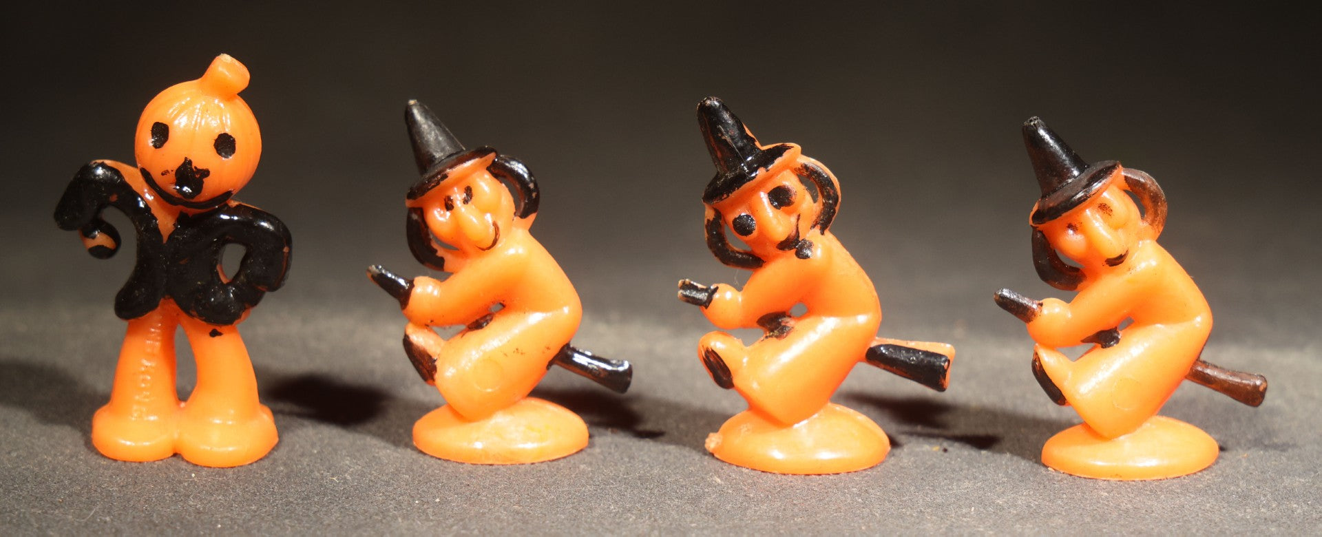 Grouping of Four Vintage Plastic Halloween Cupcake Toppers including Jack-O-Lantern Pumpkin Head Figure and Three Witches on Broomsticks, Hong Kong