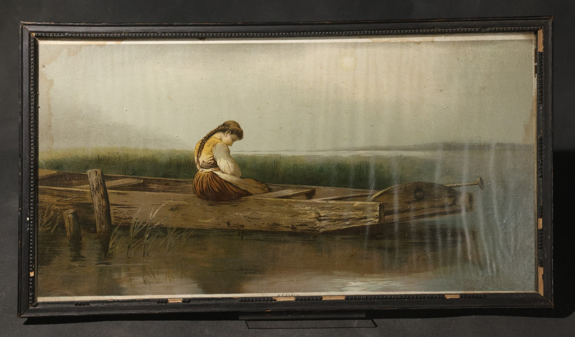 Antique Framed Chromolithograph Print, "Alone," after Heinrich Vosberg's "Mädchen im Kahn" ("Girl in a Boat"), Young Woman Seated in a Wooden Boat at a Dock
