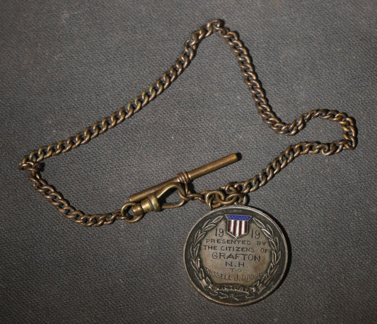 Antique World War I Victory Medal on Watch Chain, Presented by the Citizens of Grafton, New Hampshire to Russell J. Dodge, Enameled American Shield and Laurel Wreath, 1919
