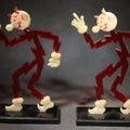 Lot 046 - Pair of Vintage Reddy Kilowatt Figural Display Advertising Pieces, Red Lightning Bolt Body with Cream Head, Hands, and Feet on Black Base, Circa 1950s-1960s, 5-1/2" H each