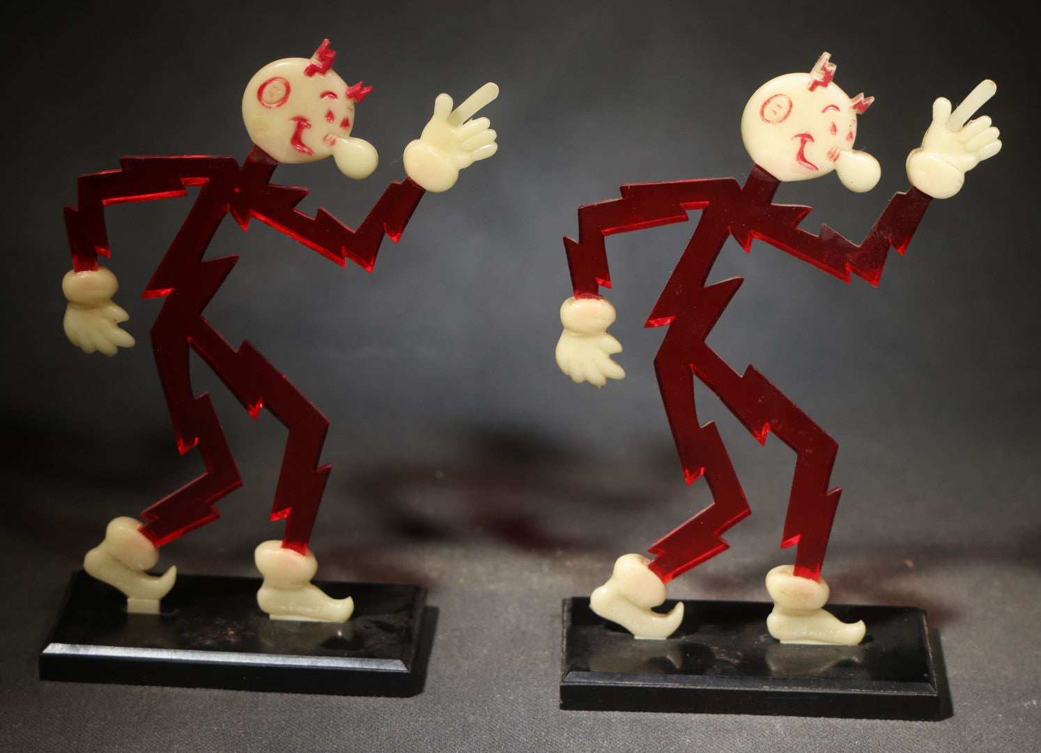 Pair of Vintage Reddy Kilowatt Figural Display Advertising Pieces, Red Lightning Bolt Body with Cream Head, Hands, and Feet on Black Base, Circa 1950s-1960s