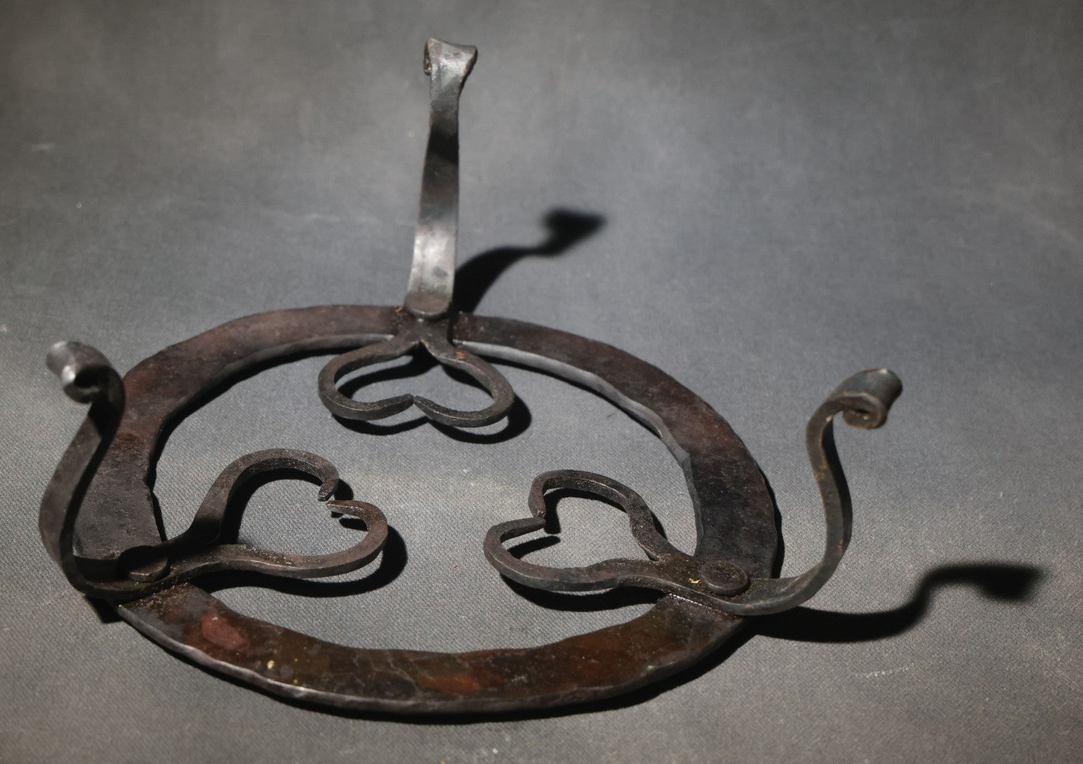 Antique Wrought Iron Footed Trivet with Heart-Shaped Scrollwork Design