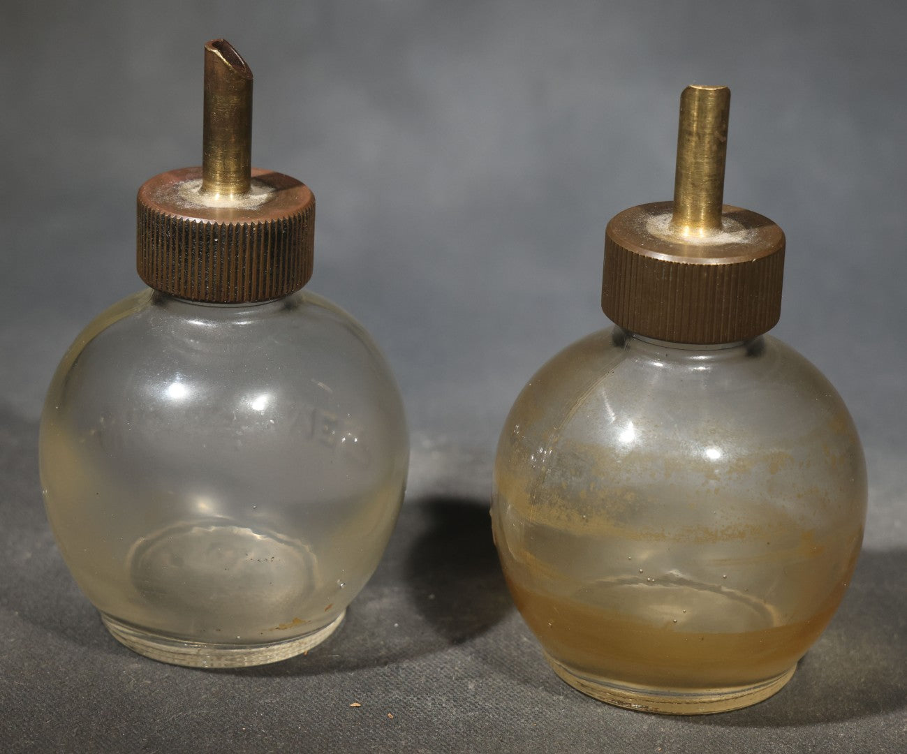 Pair of Vintage Lunkenheimer Glass Oiler Bottles with Brass Spouts