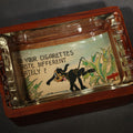 Lot 076 - Vintage Novelty Postcard Ashtray with Wood Base and Glass Tray, Includes "Do Your Cigarettes Taste Different Lately?" Dog and Tobacco Comic Postcard, Made in U.S.A., 6-3/4" L