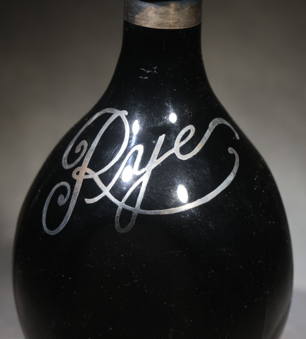 Antique Black Glass "Rye" Back Bar Bottle with Silver Overlay Script Lettering, Pinched Body, and Metal Collar