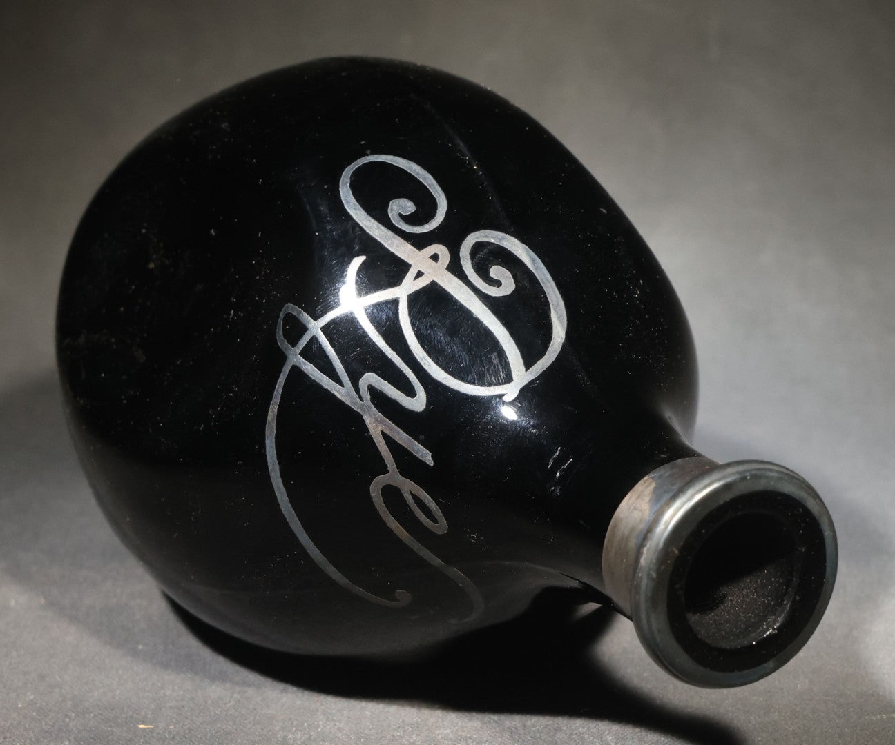 Antique Black Glass "Rye" Back Bar Bottle with Silver Overlay Script Lettering, Pinched Body, and Metal Collar