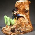 Lot 083 - Vintage "Blue Ridge Mt. Boys" Figural Pitcher by Paul Webb, Barefoot Man Leaning Against Tree Stump with Jug and Snake, Manufactured by Imperial Porcelain Corp., Zanesville, Ohio, 1946, 5" H