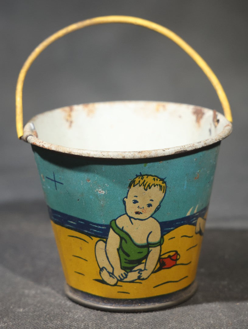 Vintage Tin Lithograph Toy Sand Pail with Beach Scene of Children Playing in Sand, Wire Bail Handle