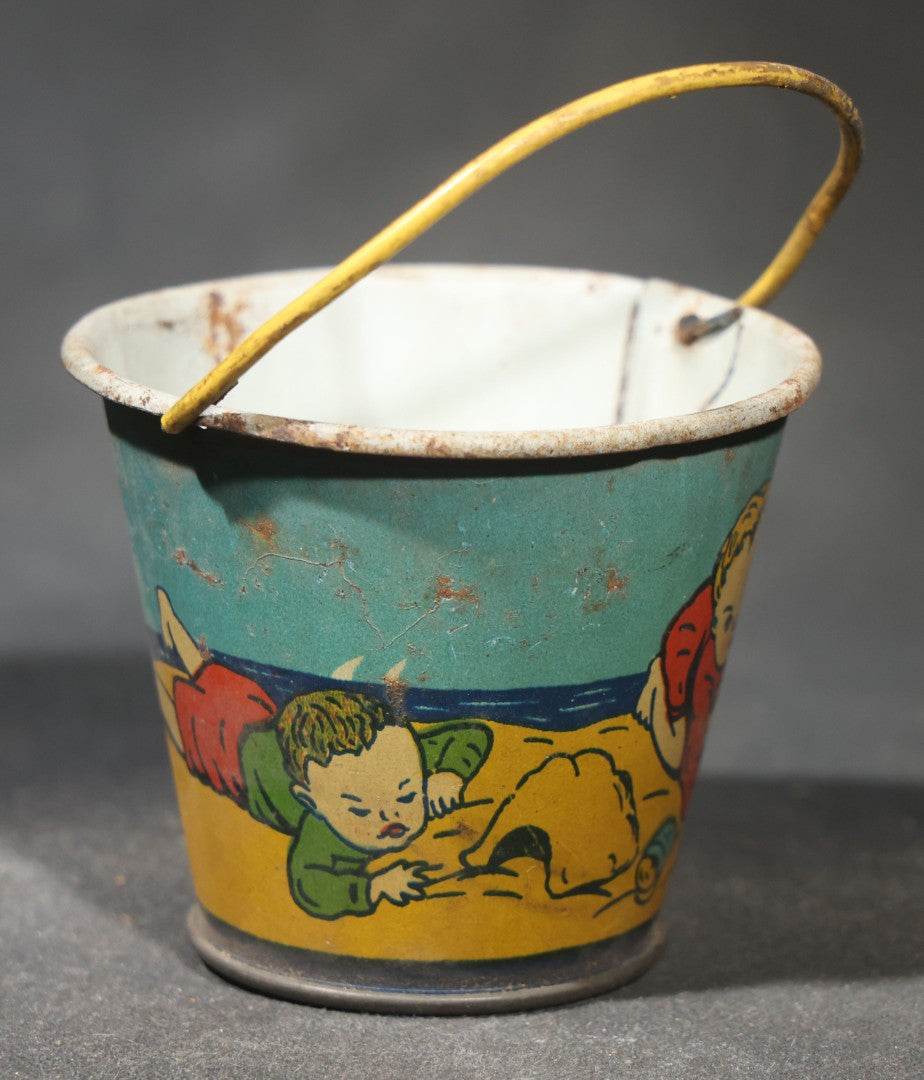Vintage Tin Lithograph Toy Sand Pail with Beach Scene of Children Playing in Sand, Wire Bail Handle