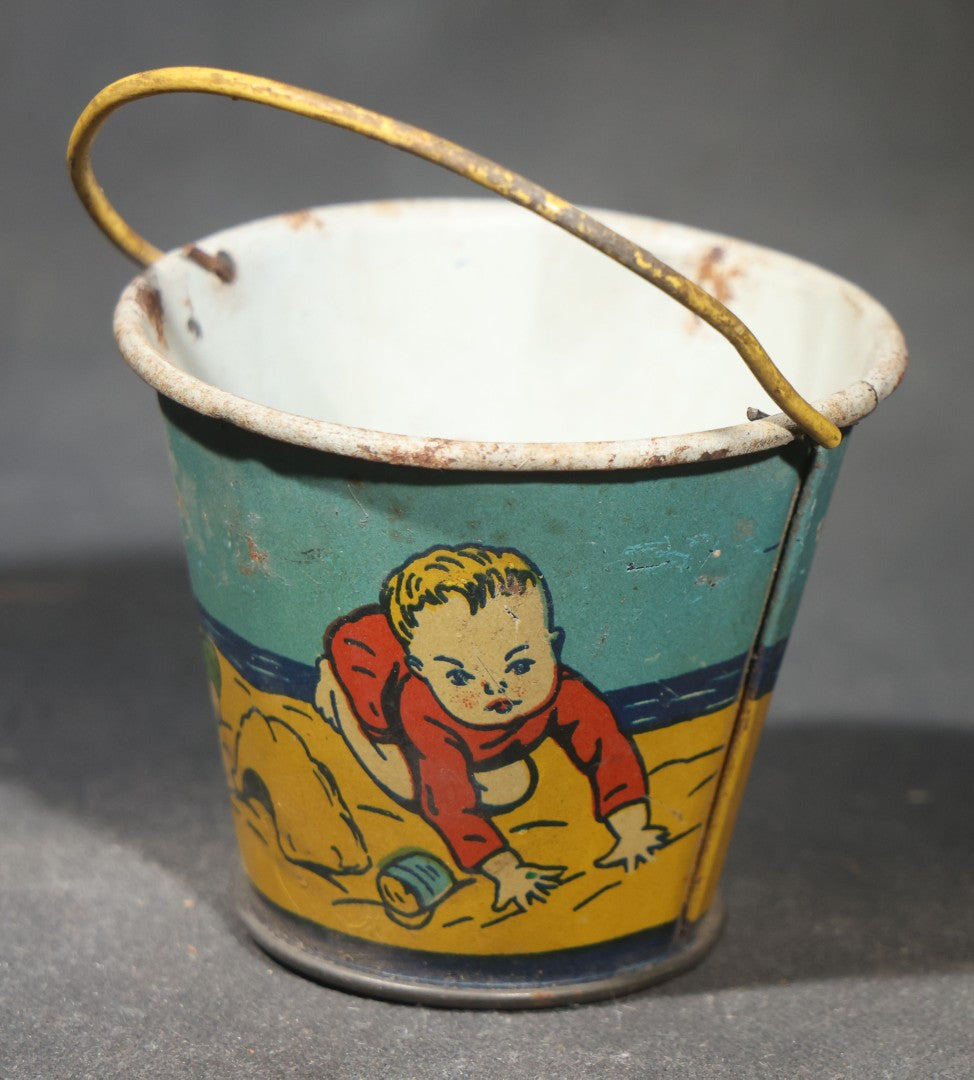Vintage Tin Lithograph Toy Sand Pail with Beach Scene of Children Playing in Sand, Wire Bail Handle