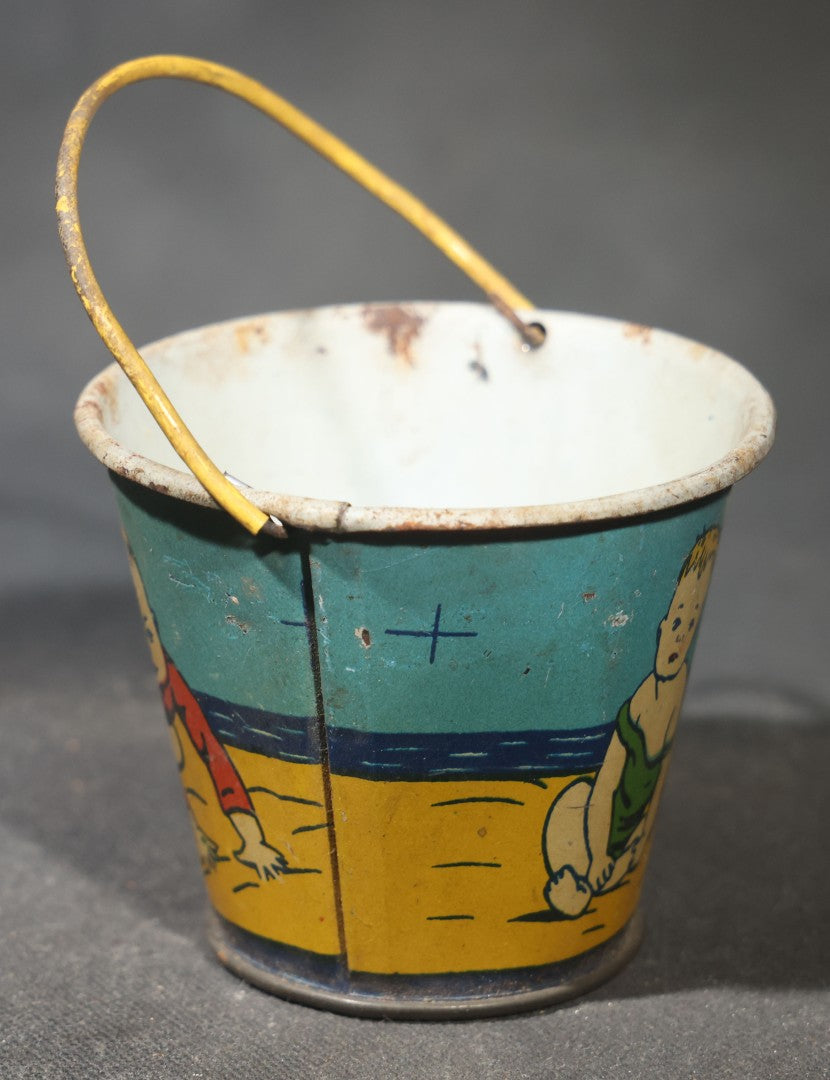 Vintage Tin Lithograph Toy Sand Pail with Beach Scene of Children Playing in Sand, Wire Bail Handle