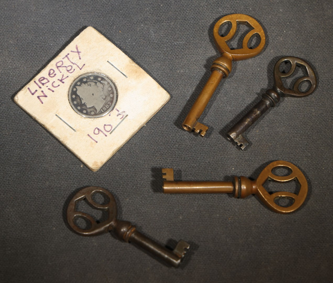 Grouping of Five Antique Items including Four Skeleton Keys and a 1903 Liberty Head V Nickel in Cardboard Coin Holder