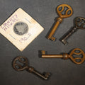 Lot 094 - Grouping of Five Antique Items Including Four Skeleton Keys and a 1903 Liberty Head V Nickel in Cardboard Coin Holder