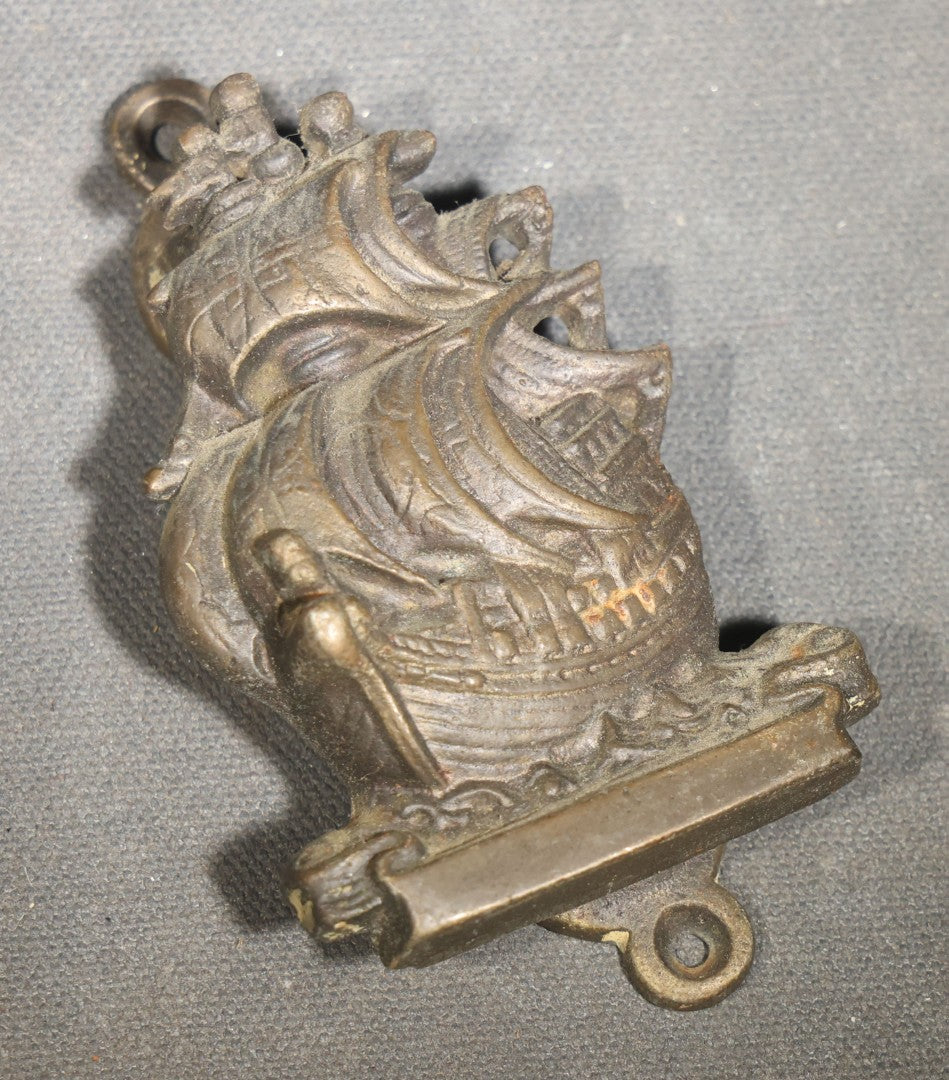 Grouping of Seven Vintage Smalls including Cast Metal Sailing Ship Door Knocker, Toy Race Car with Driver, Two Painted Native American Chief Figures, Two Pocket Knives, and Bear Bookmark