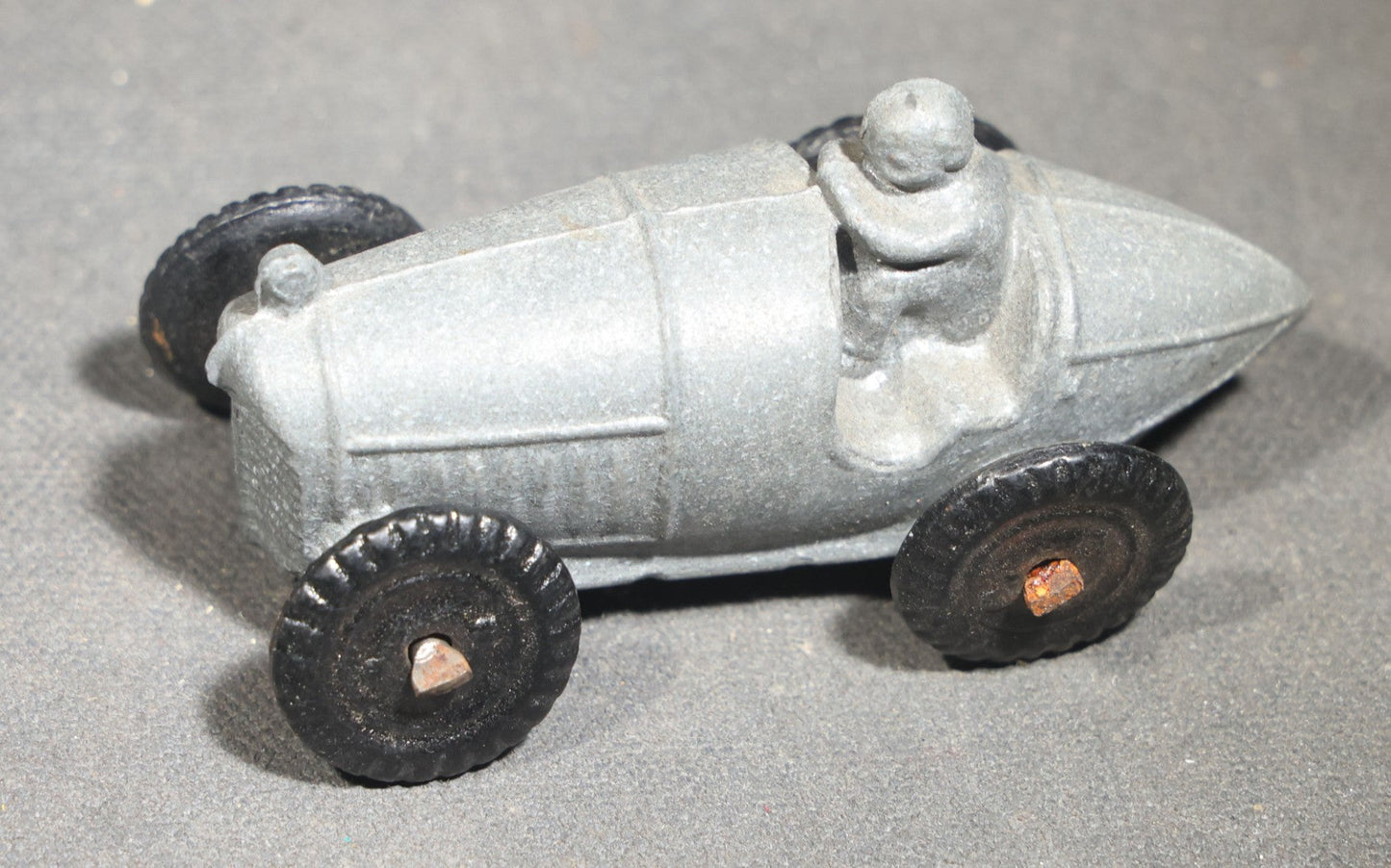 Grouping of Seven Vintage Smalls including Cast Metal Sailing Ship Door Knocker, Toy Race Car with Driver, Two Painted Native American Chief Figures, Two Pocket Knives, and Bear Bookmark