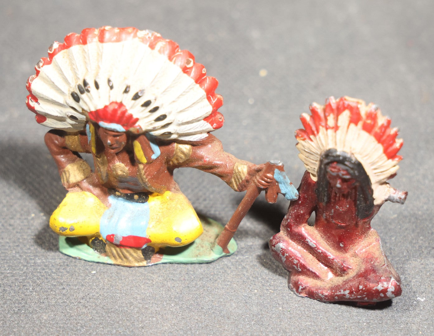 Grouping of Seven Vintage Smalls including Cast Metal Sailing Ship Door Knocker, Toy Race Car with Driver, Two Painted Native American Chief Figures, Two Pocket Knives, and Bear Bookmark