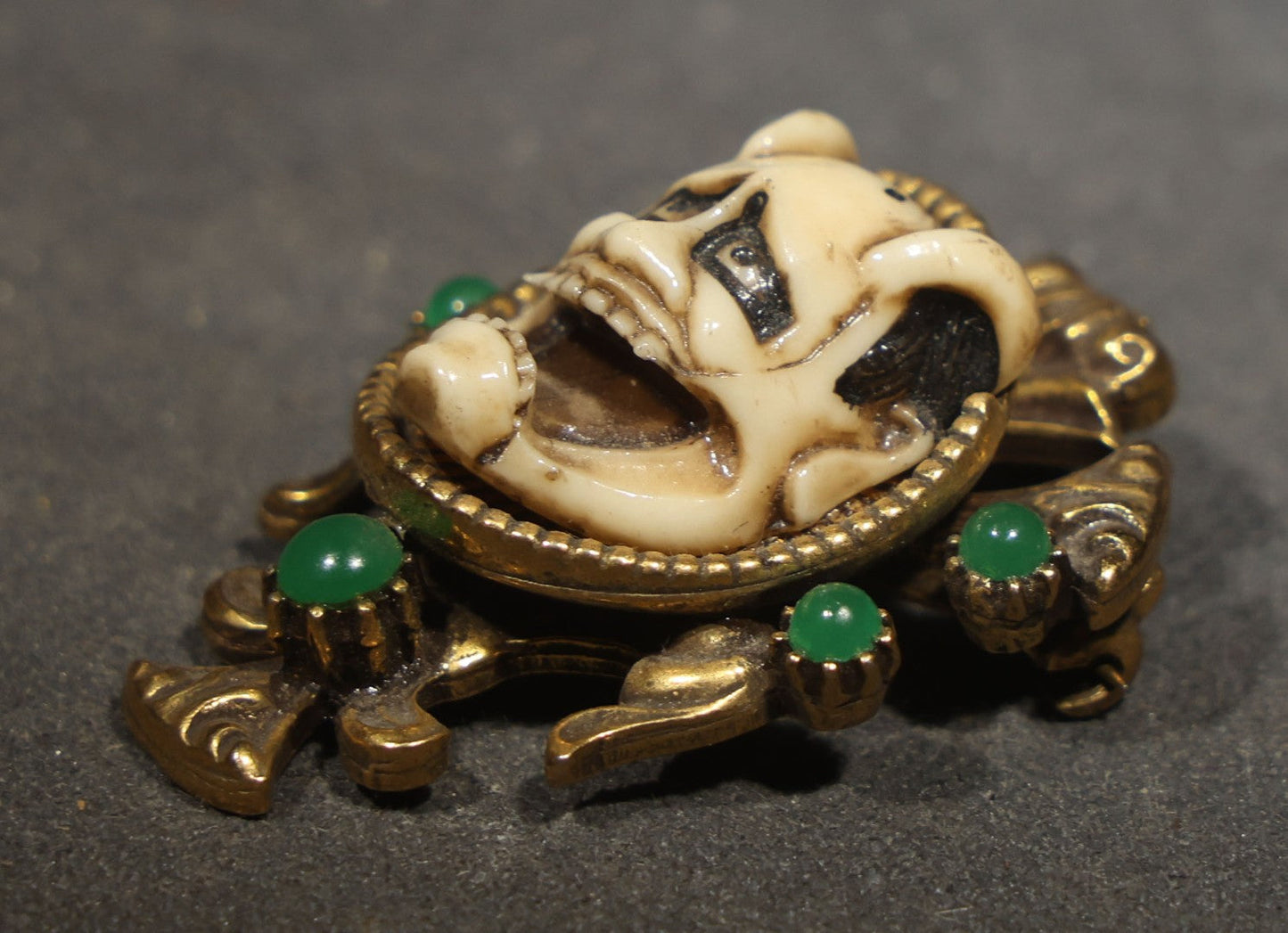 Vintage Cast Resin Japanese Hannya Mask Brooch with Green Cabochons and Gold-Tone Scrollwork Setting
