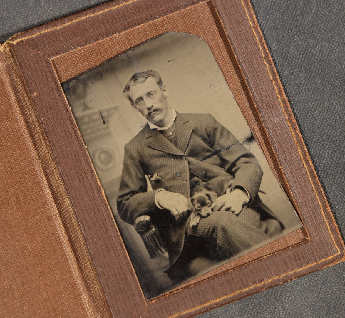 Antique Foldered Tintype Photograph of a Man Holding a Small Dog