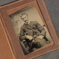Lot 131 - Antique Foldered Tintype Photograph of a Man Holding a Small Dog