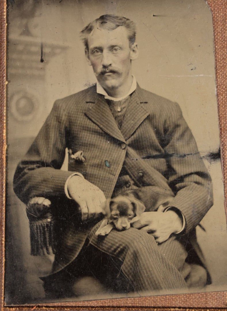 Antique Foldered Tintype Photograph of a Man Holding a Small Dog