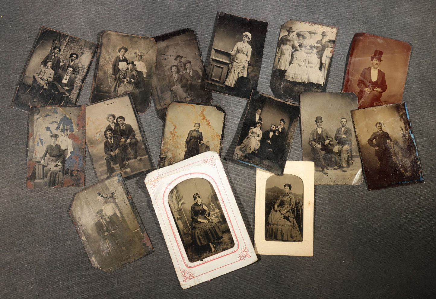 Grouping of 15 Antique Tintype Photographs including Man in Top Hat with Cane, Group of Women in White Dresses and Hats, Seated Couples, and Paper-Matted Portrait of a Seated Woman