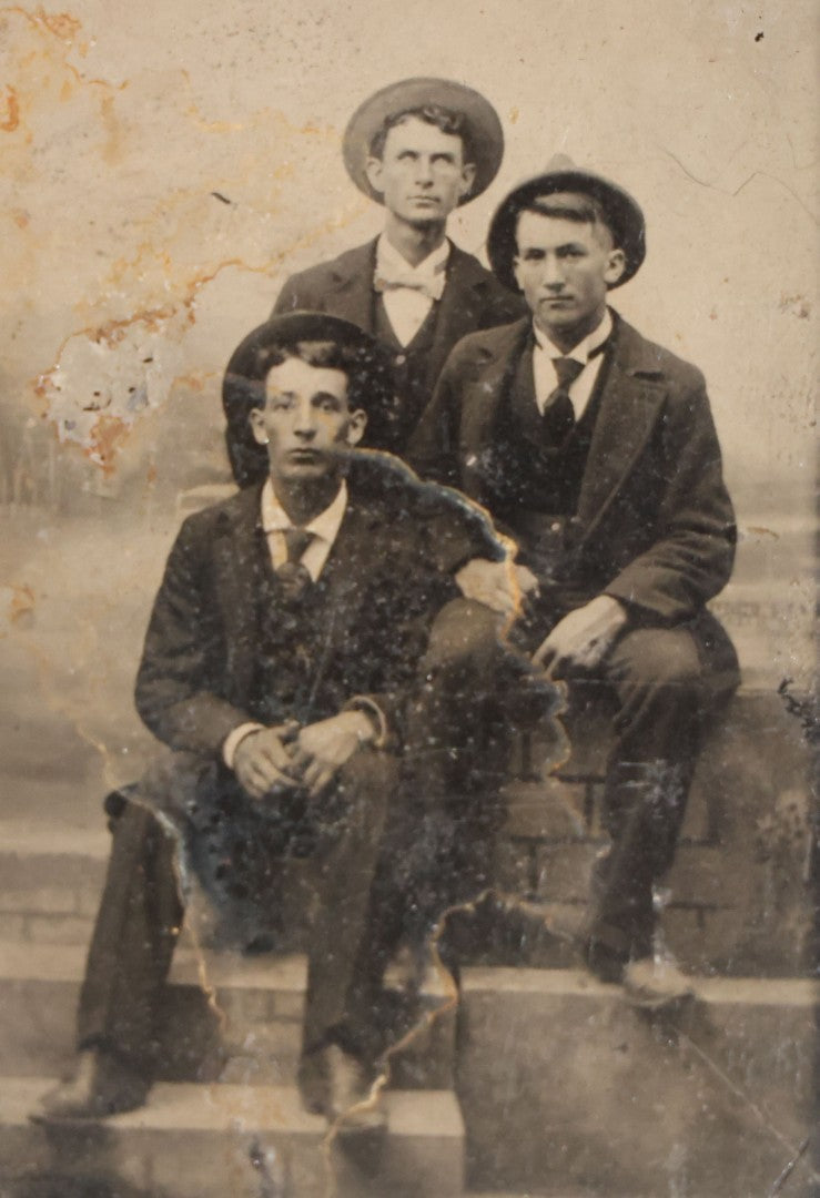 Grouping of 15 Antique Tintype Photographs including Man in Top Hat with Cane, Group of Women in White Dresses and Hats, Seated Couples, and Paper-Matted Portrait of a Seated Woman