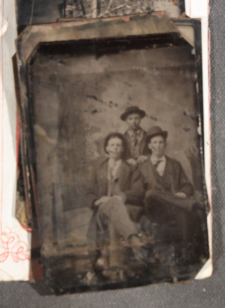 Grouping of 15 Antique Tintype Photographs including Man in Top Hat with Cane, Group of Women in White Dresses and Hats, Seated Couples, and Paper-Matted Portrait of a Seated Woman