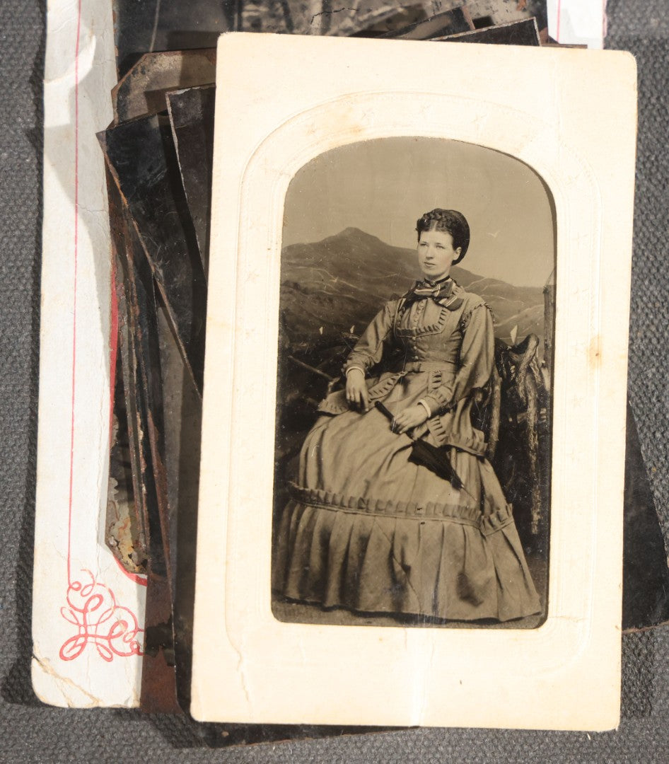 Grouping of 15 Antique Tintype Photographs including Man in Top Hat with Cane, Group of Women in White Dresses and Hats, Seated Couples, and Paper-Matted Portrait of a Seated Woman
