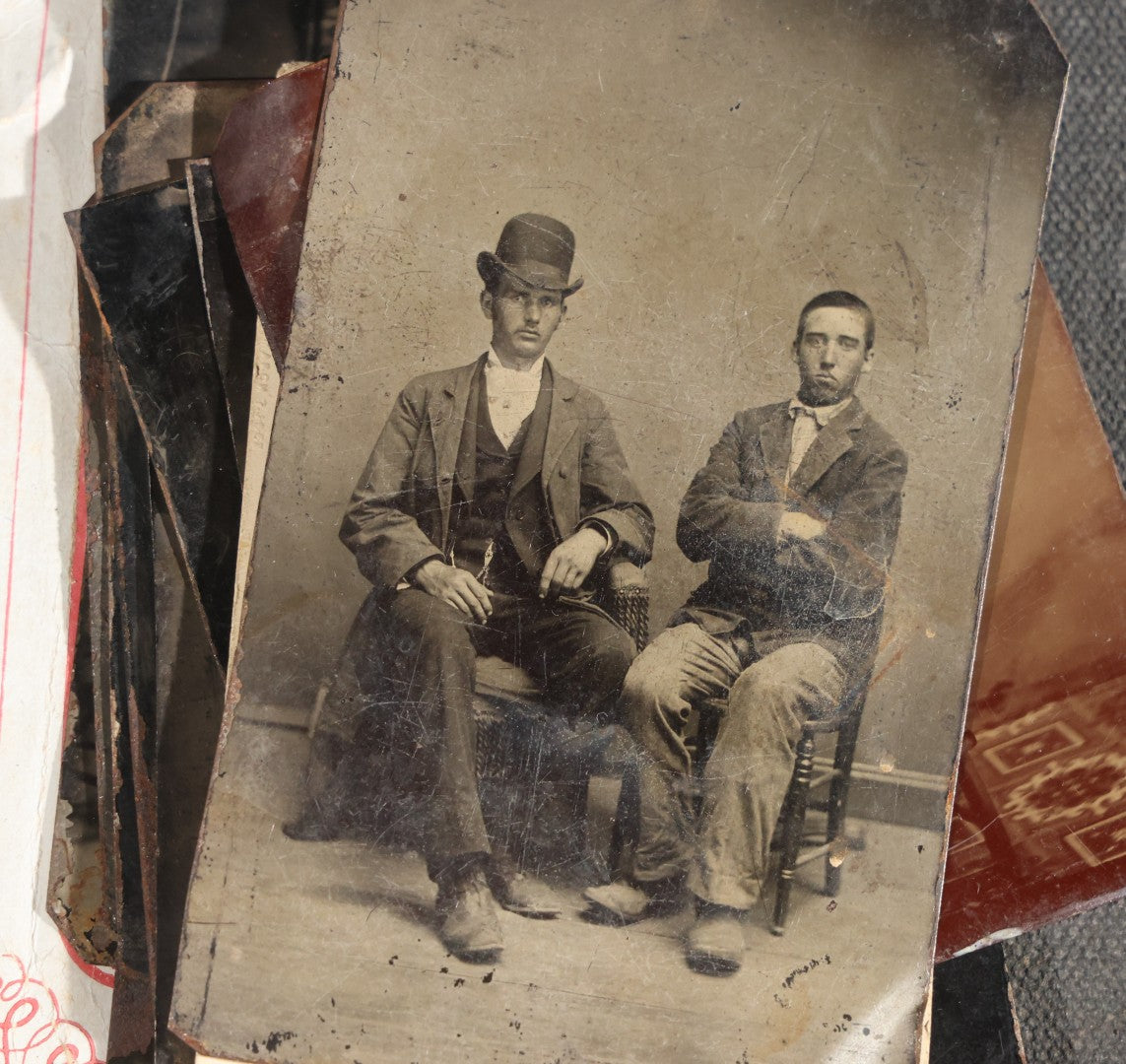 Grouping of 15 Antique Tintype Photographs including Man in Top Hat with Cane, Group of Women in White Dresses and Hats, Seated Couples, and Paper-Matted Portrait of a Seated Woman