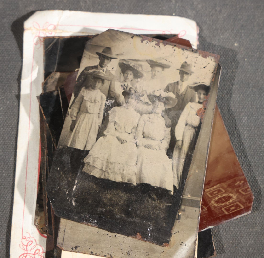 Grouping of 15 Antique Tintype Photographs including Man in Top Hat with Cane, Group of Women in White Dresses and Hats, Seated Couples, and Paper-Matted Portrait of a Seated Woman