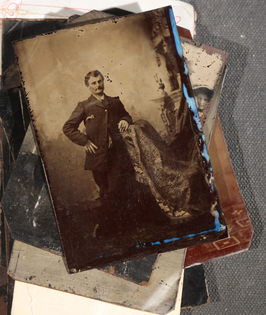 Grouping of 15 Antique Tintype Photographs including Man in Top Hat with Cane, Group of Women in White Dresses and Hats, Seated Couples, and Paper-Matted Portrait of a Seated Woman
