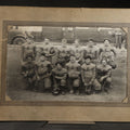Lot 138 - Antique Board-Mounted Photograph of a Football Team in "E" Letter Jerseys with Striped Sleeves, 12 Players with Leather Helmets and Footballs, Photographed by Photo Shop, Butte, Montana, Circa 1920s