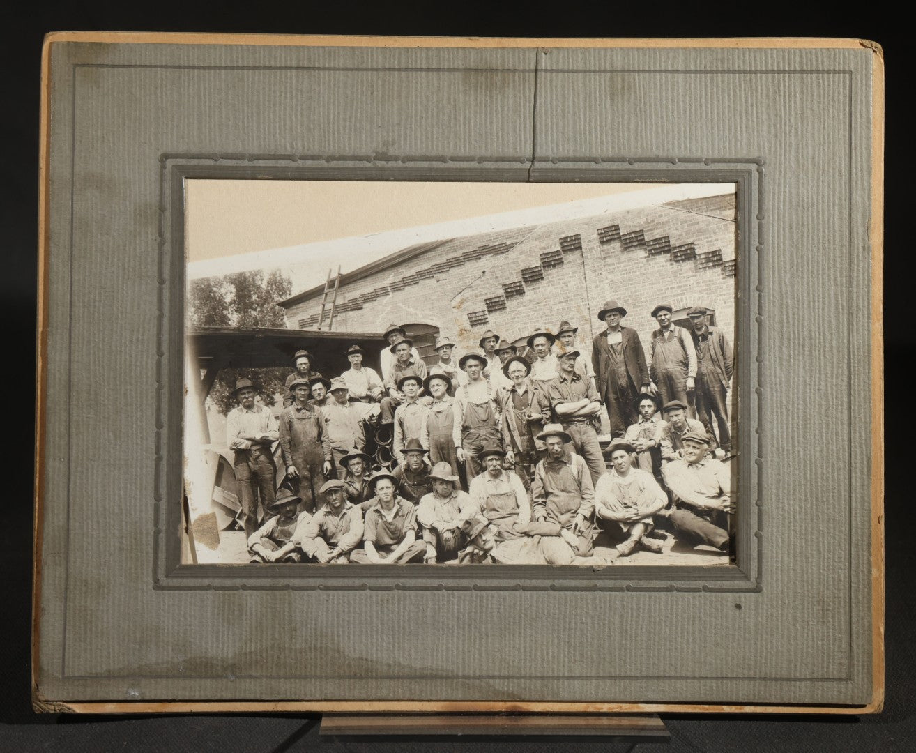 Antique Occupational Photograph of a Large Crew of Workers Posed in Front of a Brick Industrial Building, in Paper Frame