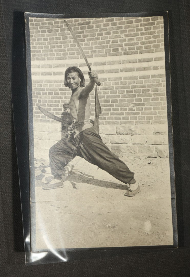 Grouping of 12 Antique Snapshot Photographs, East Asian and Russian-Language Settings including Sword Performer, Street Performer with Knife, Man with Trained Bear, Fishermen with Crabs, Construction Workers, and Children